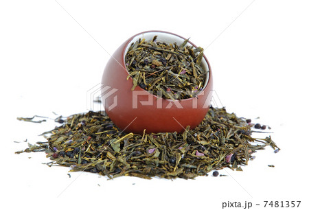 Cup of dried green tea 7481357