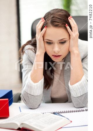 worried woman with book 7482210