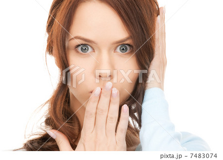 woman with hand over mouth woman with hand over mouth 7483074