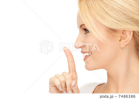 happy woman with finger on lips 7486386