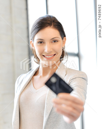 happy woman with credit card 7489692