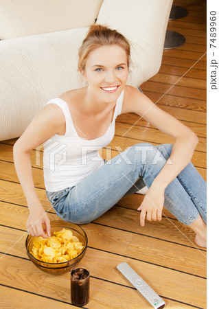 smiling teenage girl with remote control smiling teenage girl with remote control 7489960