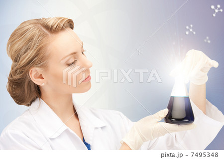 lab worker holding up test tube 7495348
