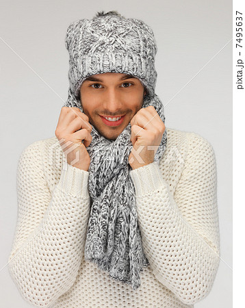 handsome man in warm sweater, hat and scarf 7495637