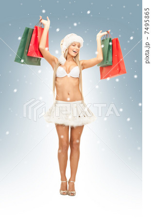 cheerful santa helper with shopping bags 7495865