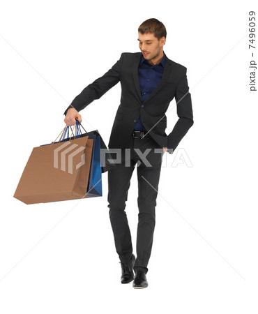 handsome man in suit with shopping bags 7496059