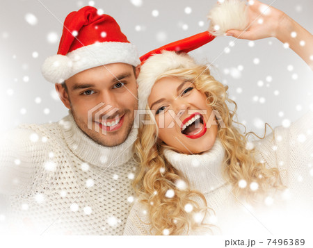family couple in sweaters and santas hats family couple in sweaters and santas hats 7496389