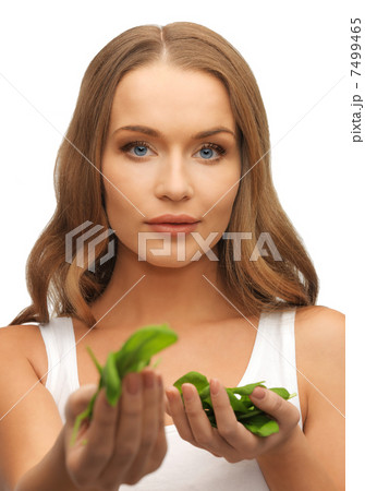 woman with spinach leaves on palms woman with spinach leaves on palms 7499465