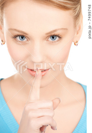 woman with finger on her lips woman with finger on her lips 7499748