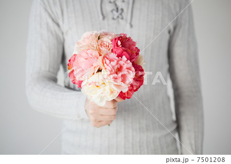 man holding bouquet of flowers 7501208