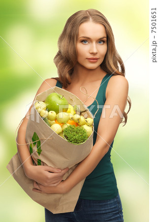 woman with shopping bag full of fruits 7501651