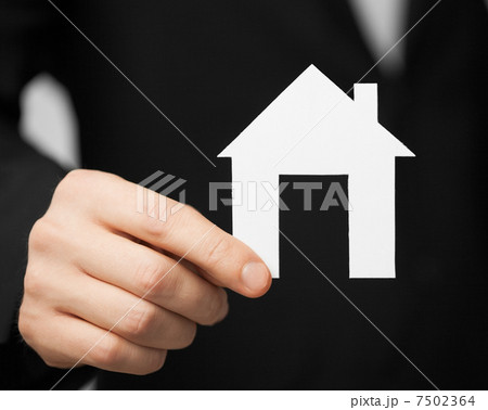 man in suit holding paper house 7502364