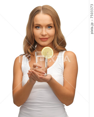 woman with lemon slice on glass of water woman with lemon slice on glass of water 7503373