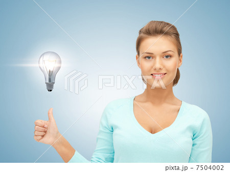 woman with light bulb showing thumbs up woman with light bulb showing thumbs up 7504002