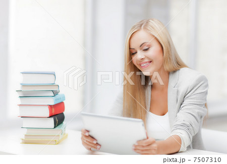 student with books and tablet pc 7507310