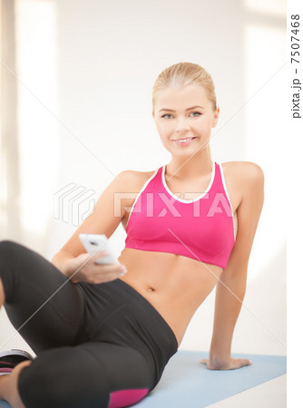 woman sitting on the floor with smartphone 7507468