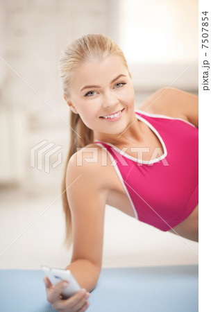 woman lying on the floor with smartphone woman lying on the floor with smartphone 7507854