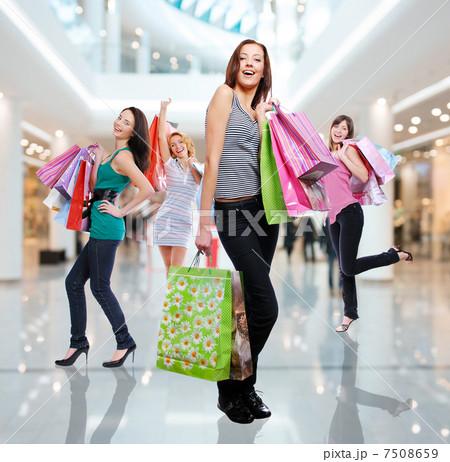 Women with shopping bags at shop 7508659