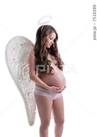 Beautiful pregnant woman posing in angel costume Beautiful pregnant woman posing in angel costume 7510389