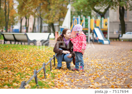 Mother and daughter together at the playground 7517694