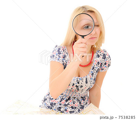 Attractive young blonde holding magnifying glass Attractive young blonde holding magnifying glass 7538285