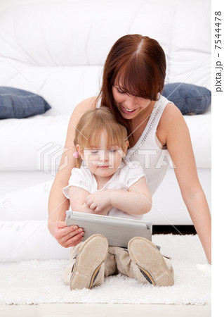 Mother and daughter using a tablet pc Mother and daughter using a tablet pc 7544478