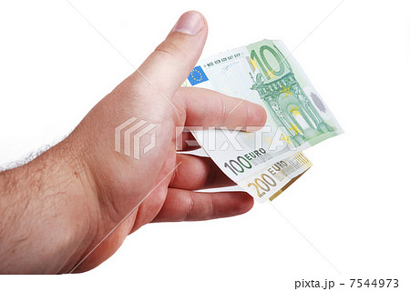 Male hand is holding euro between fingers 7544973