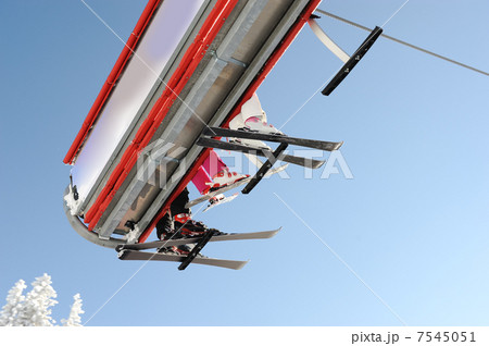 Sky sky lift carrying skiers. 7545051