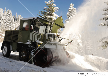 Special winter vehicle for removing snow from road in action Special winter vehicle for removing snow from road in action 7545099
