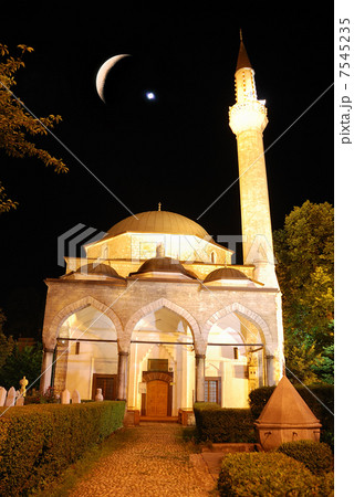 Mosque in night with crescent and star above 7545235