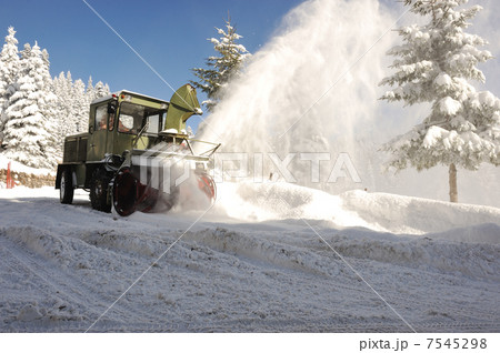 Special winter vehicle for removing snow from road in action Special winter vehicle for removing snow from road in action 7545298
