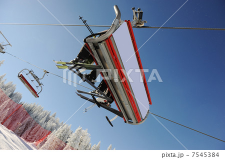 Sky sky lift carrying skiers. 7545384