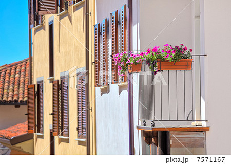 Flowers in the pots on house balcony in Italy. 7571167