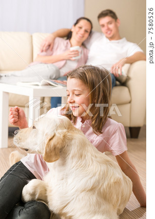 Playful girl petting family dog with parents Playful girl petting family dog with parents 7580526