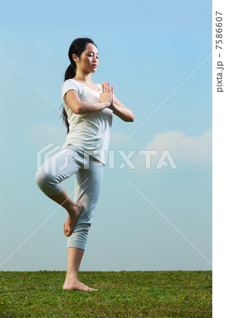 Chinese woman meditating and in yoga pose 7586607