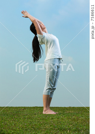 Chinese woman meditating and in yoga pose 7586611