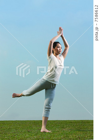 Chinese woman meditating and in yoga pose 7586612
