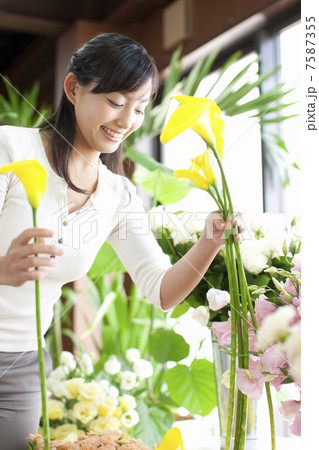 カラーの花を手に取る女性 7587355