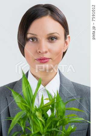 Adult business woman holding lucky bamboo plant symbol of succes Adult business woman holding lucky bamboo plant symbol of succes 7591012