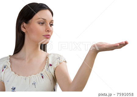 Portrait of charming young woman presenting your product over wh 7591058