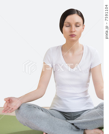 Portrait of pretty young woman doing yoga exercise on mat Portrait of pretty young woman doing yoga exercise on mat 7591104