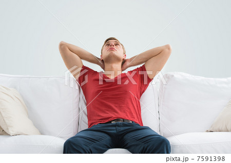 Portrait of a handsome young man looking upwards while relaxing 7591398