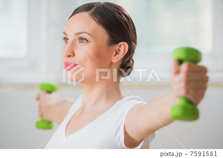 Portrait of fitness woman working out with free weights in gym Portrait of fitness woman working out with free weights in gym 7591581