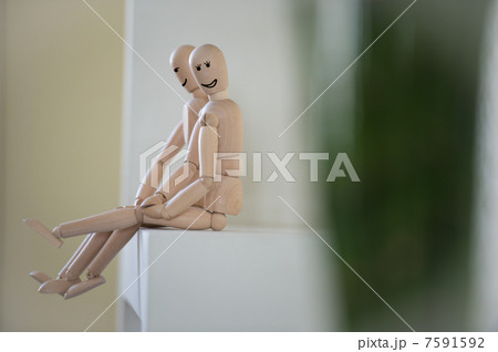 Wooden people sitting at home and hugging. People relationship c Wooden people sitting at home and hugging. People relationship c 7591592