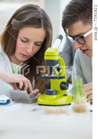 High School students. Girl and boy working together at biology c 7591821