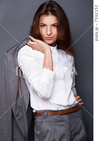 Portrait of a beautiful young business woman standing with hand Portrait of a beautiful young business woman standing with hand 7592152