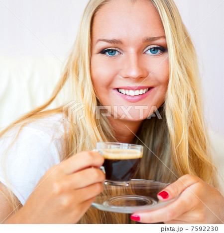Closeup portrait of a pretty young female having a cup of coffee Closeup portrait of a pretty young female having a cup of coffee 7592230