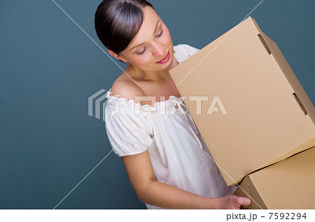 Closeup portrait of a young woman with boxes Closeup portrait of a young woman with boxes 7592294