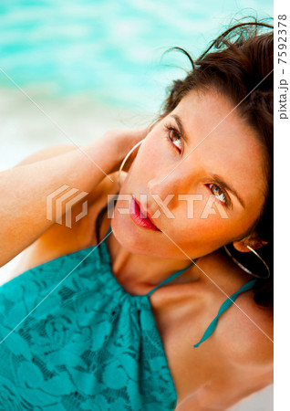 Pretty young woman with hot look and sexy smile sitting on beach Pretty young woman with hot look and sexy smile sitting on beach 7592378