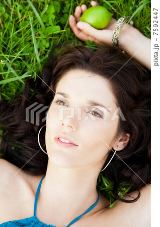 Pretty brunette woman wearing elegant dress relaxing outdoor in Pretty brunette woman wearing elegant dress relaxing outdoor in 7592447